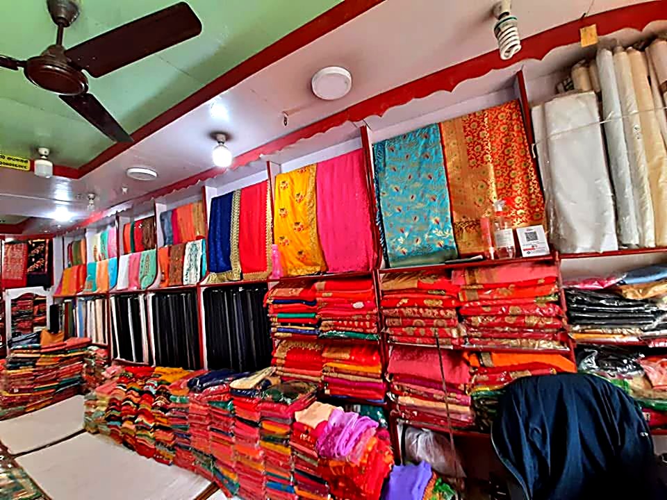 Shelves of folded sarees and fabric inside P and P Suppliers