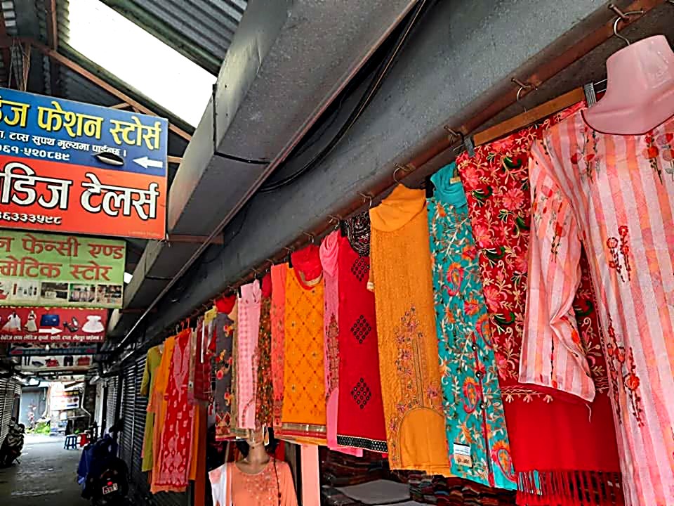 Rack of colourful kurtis and tops hanging outside P and P Suppliers